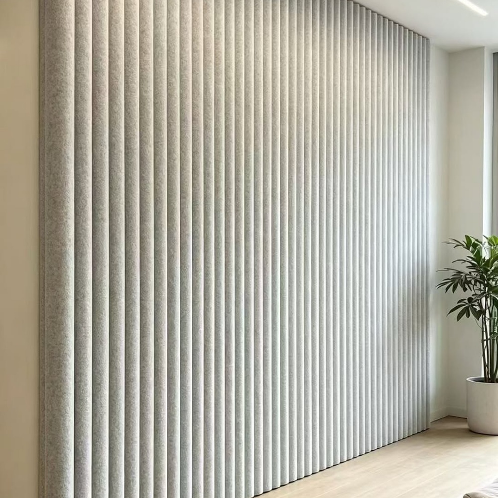 Indoor full‑wall installation of light grey vertical ribbed 3D acoustic panels